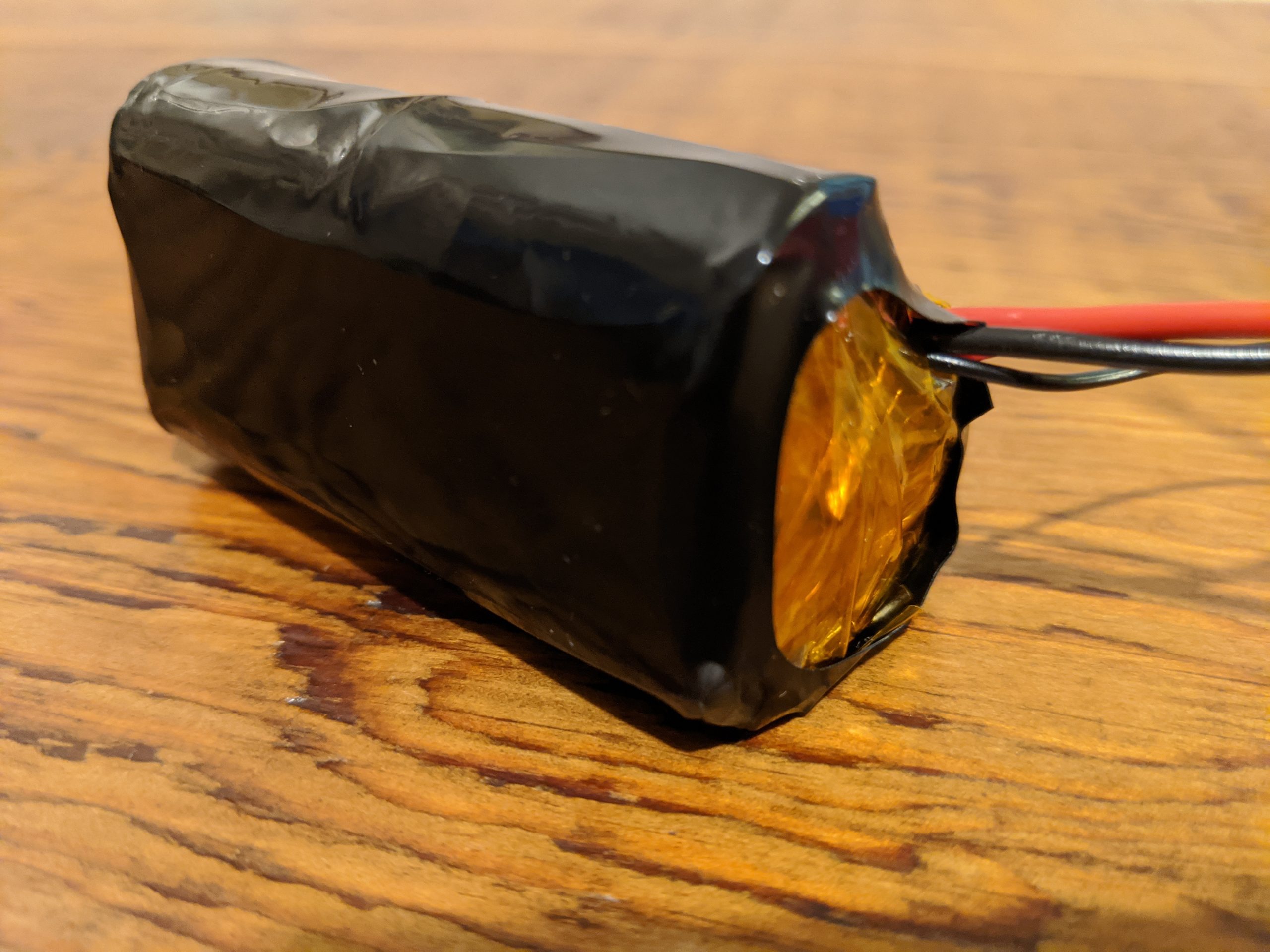 A finished battery, encased in kapton tape and shrink wrap
